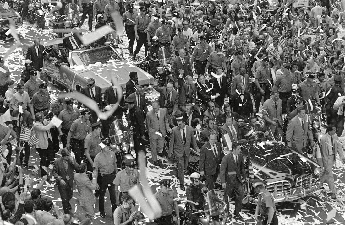 Edwin Aldrin, Michael Collins, Neil Armstrong Apollo 11 astronauts wave from lead car of motorcade to crowd massed on both sides of the street during parade up lower Broadway in August 1969 (Rh/AP/Shutterstock)